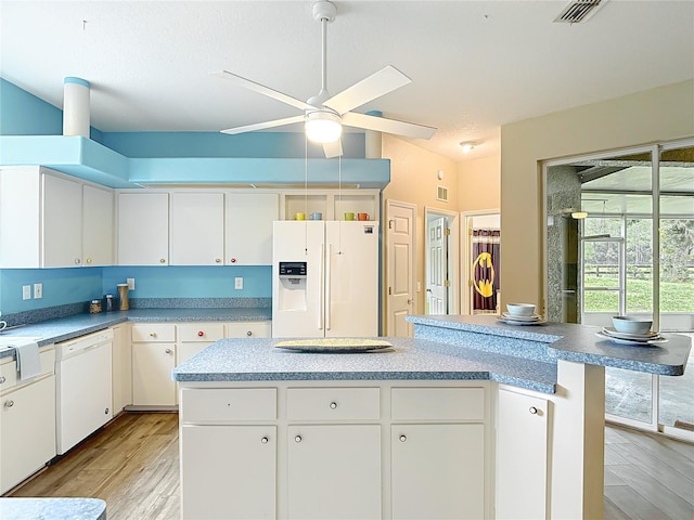 1332 Osceola Hollow Rd, Odessa, FL 33556 - kitchen with white appliances, a ceiling fan, light wood finished floors, and white cabinets
