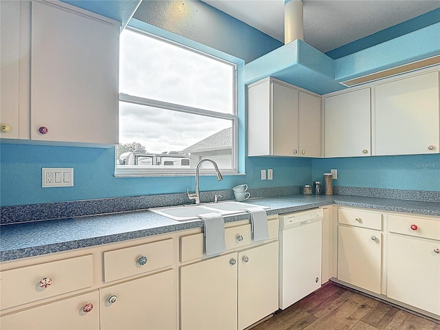 1332 Osceola Hollow Rd, Odessa, FL 33556 - kitchen with white dishwasher, dark wood-type flooring, a sink, dark countertops, and cream cabinetry