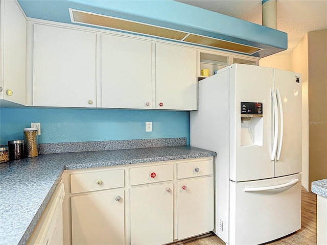 1332 Osceola Hollow Rd, Odessa, FL 33556 - kitchen with white refrigerator with ice dispenser, white cabinetry, and light wood-type flooring