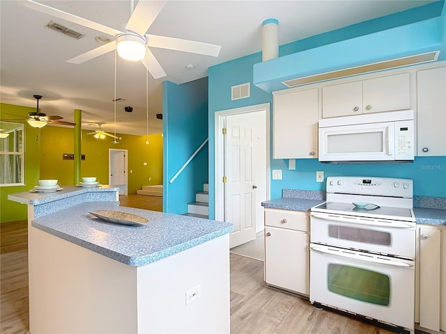 1332 Osceola Hollow Rd, Odessa, FL 33556 - kitchen with white appliances, ceiling fan, light wood-style floors, and white cabinetry