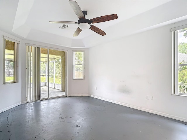 1332 Osceola Hollow Rd, Odessa, FL 33556 - unfurnished room with concrete floors, a raised ceiling, baseboards, and ceiling fan