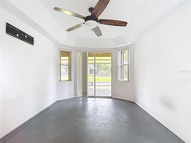 1332 Osceola Hollow Rd, Odessa, FL 33556 - spare room with a raised ceiling, unfinished concrete flooring, baseboards, and ceiling fan