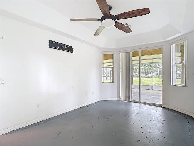 1332 Osceola Hollow Rd, Odessa, FL 33556 - empty room featuring concrete flooring, baseboards, ceiling fan, and a tray ceiling