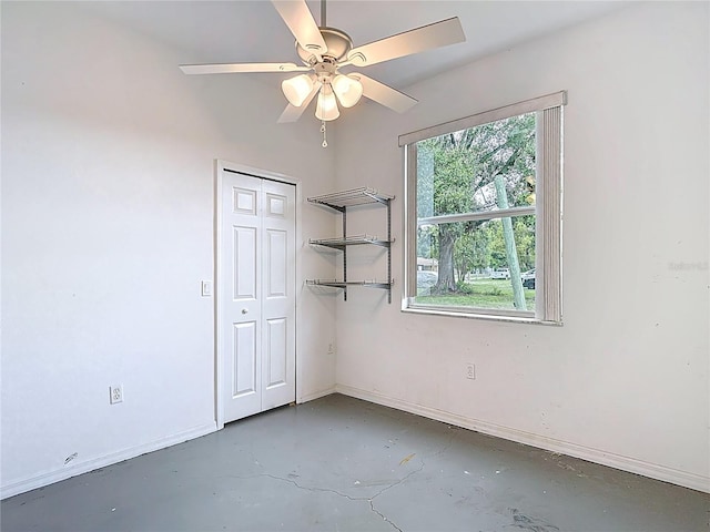1332 Osceola Hollow Rd, Odessa, FL 33556 - unfurnished bedroom featuring concrete floors, baseboards, a closet, and a ceiling fan