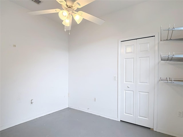 1332 Osceola Hollow Rd, Odessa, FL 33556 - unfurnished bedroom featuring concrete flooring, a closet, baseboards, and a ceiling fan