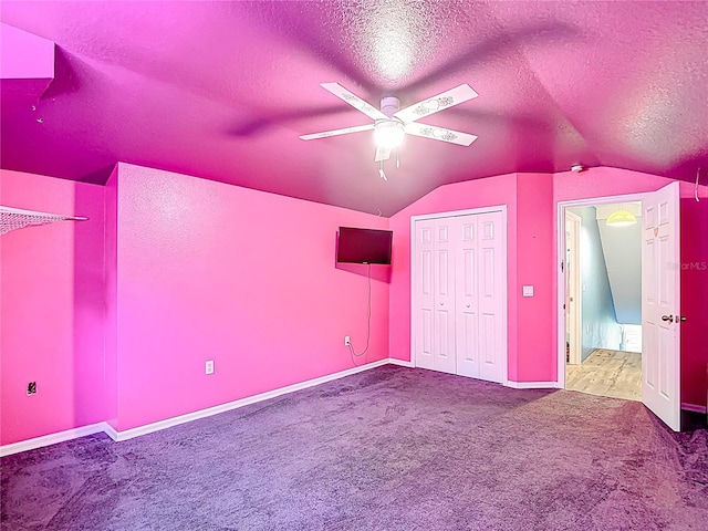 1332 Osceola Hollow Rd, Odessa, FL 33556 - unfurnished bedroom featuring vaulted ceiling, carpet flooring, a textured ceiling, baseboards, and a ceiling fan
