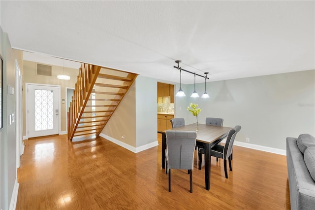 1111 N Bayshore Blvd Unit E10, Clearwater, FL 33759 - dining room featuring stairs and light wood-type flooring