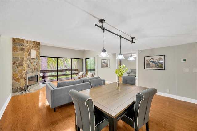 1111 N Bayshore Blvd Unit E10, Clearwater, FL 33759 - dining space with wood finished floors, rail lighting, and a fireplace