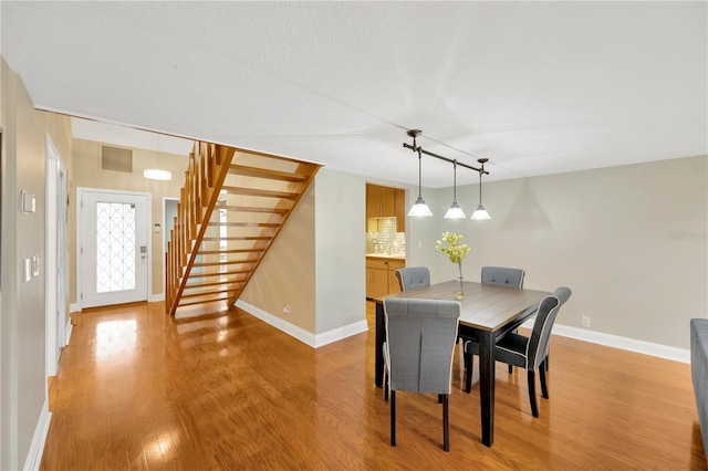 1111 N Bayshore Blvd Unit E10, Clearwater, FL 33759 - dining area with stairs and light wood-style floors