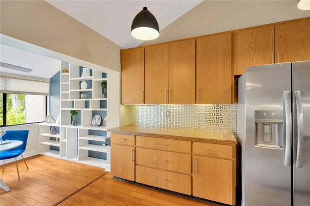1111 N Bayshore Blvd Unit E10, Clearwater, FL 33759 - kitchen featuring stainless steel refrigerator with ice dispenser, lofted ceiling, decorative backsplash, light wood-type flooring, and open shelves