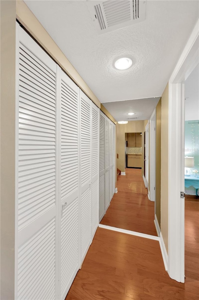 1111 N Bayshore Blvd Unit E10, Clearwater, FL 33759 - corridor featuring wood finished floors and a textured ceiling