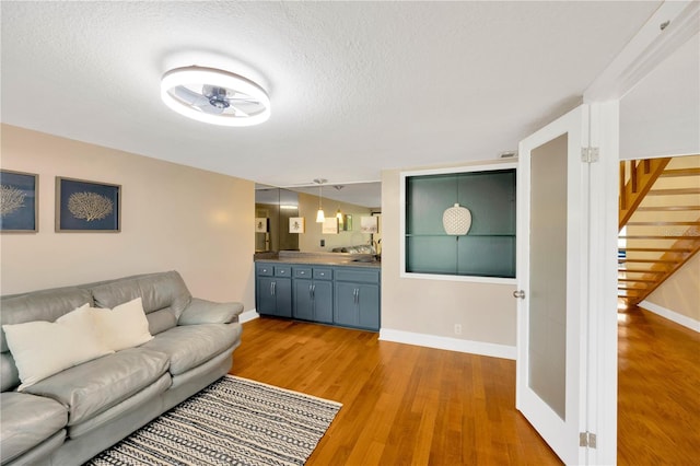 1111 N Bayshore Blvd Unit E10, Clearwater, FL 33759 - living room featuring light wood-style flooring, a textured ceiling, and ceiling fan