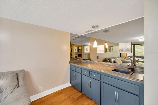 1111 N Bayshore Blvd Unit E10, Clearwater, FL 33759 - kitchen featuring open floor plan, light wood-style flooring, and pendant lighting