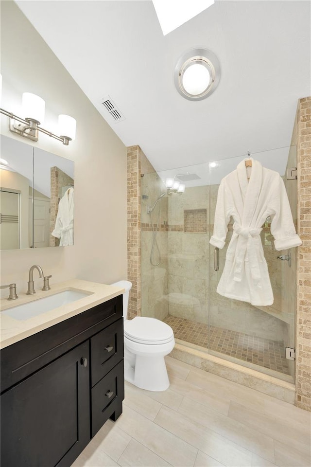 1111 N Bayshore Blvd Unit E10, Clearwater, FL 33759 - bathroom featuring a shower stall, vanity, lofted ceiling, and tile patterned floors