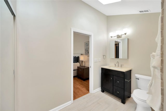 1111 N Bayshore Blvd Unit E10, Clearwater, FL 33759 - bathroom with vanity, ensuite bath, and wood finished floors