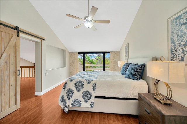 1111 N Bayshore Blvd Unit E10, Clearwater, FL 33759 - bedroom with lofted ceiling, wood finished floors, a barn door, and ceiling fan