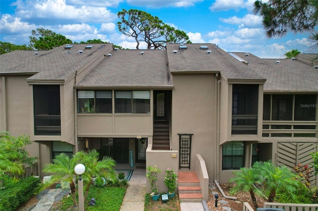 1111 N Bayshore Blvd Unit E10, Clearwater, FL 33759 - rear view of property with stucco siding and a shingled roof