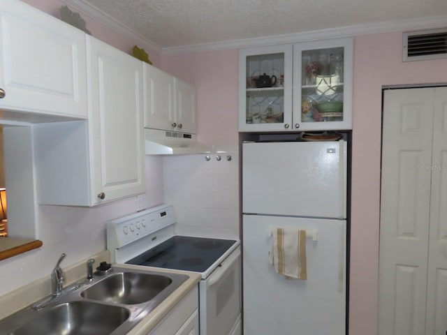 364 115th Ave N Unit 1, Saint Petersburg, FL 33716 - kitchen with white appliances, under cabinet range hood, crown molding, white cabinetry, and glass insert cabinets