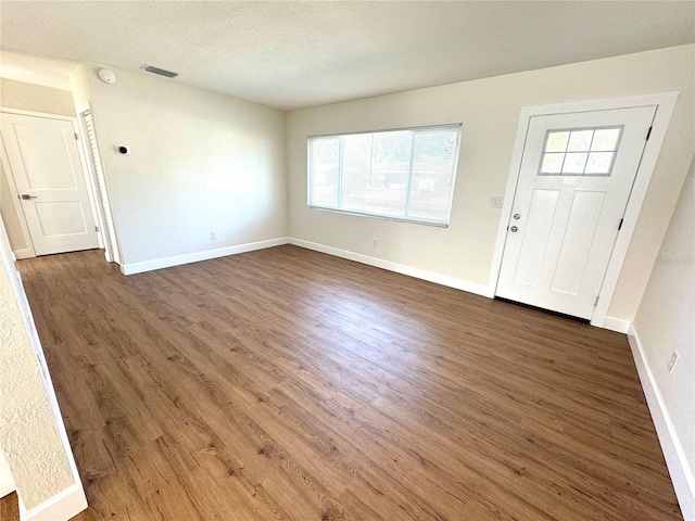 814 19th St SW, Largo, FL 33770 - entrance foyer featuring healthy amount of natural light, dark wood-type flooring, and a textured ceiling