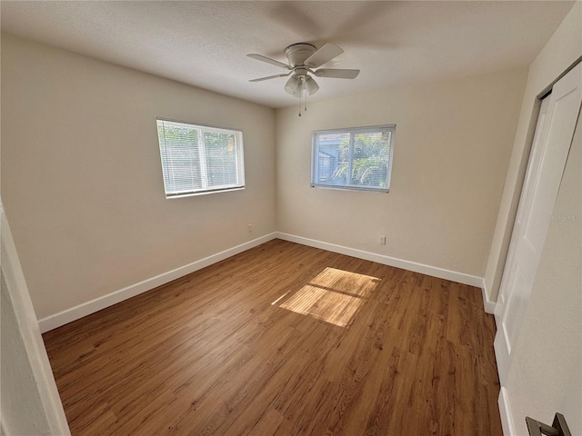 814 19th St SW, Largo, FL 33770 - unfurnished bedroom with wood finished floors, baseboards, and ceiling fan