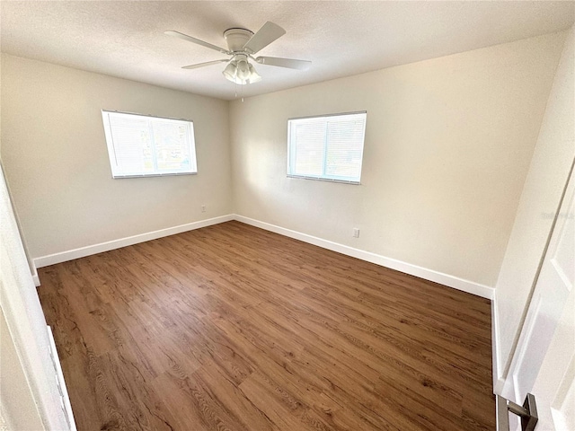 814 19th St SW, Largo, FL 33770 - spare room featuring dark wood finished floors, baseboards, and a ceiling fan