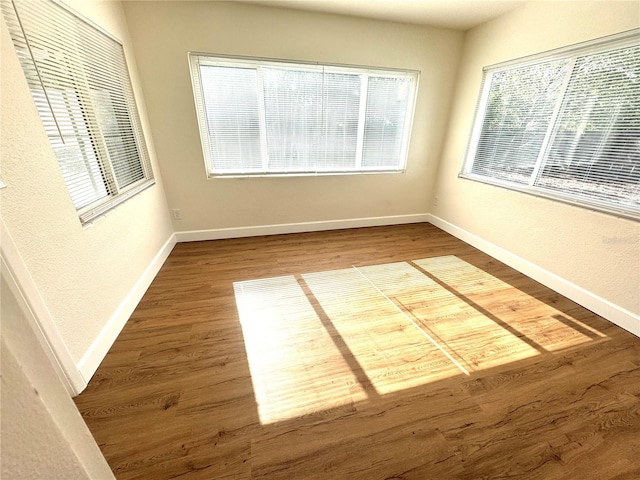 814 19th St SW, Largo, FL 33770 - spare room with wood finished floors, baseboards, and a textured wall