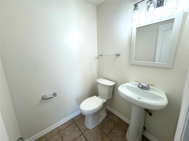 814 19th St SW, Largo, FL 33770 - bathroom featuring toilet, tile patterned floors, and baseboards