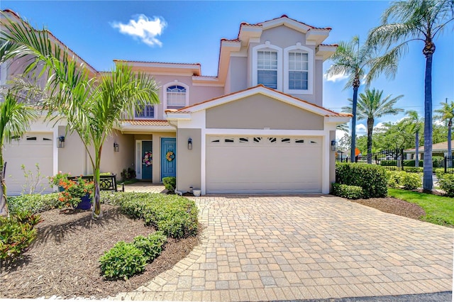 1411 Tessano Pl, Palm Harbor, FL 34683 - view of front facade with stucco siding, a tiled roof, decorative driveway, and a garage