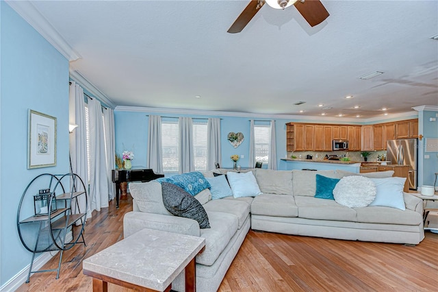 1411 Tessano Pl, Palm Harbor, FL 34683 - living room featuring ornamental molding, ceiling fan, light wood finished floors, and recessed lighting