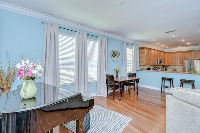 1411 Tessano Pl, Palm Harbor, FL 34683 - dining room with ornamental molding, plenty of natural light, baseboards, light wood finished floors, and recessed lighting