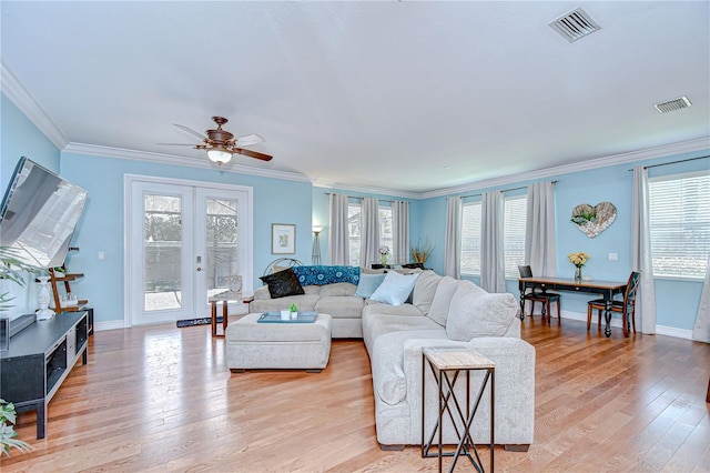 1411 Tessano Pl, Palm Harbor, FL 34683 - living room featuring light wood-type flooring, healthy amount of natural light, ornamental molding, a ceiling fan, and french doors
