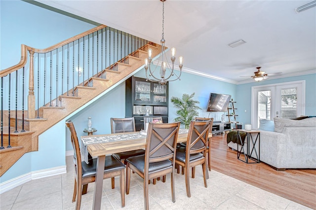 1411 Tessano Pl, Palm Harbor, FL 34683 - tiled dining room with crown molding, stairs, a ceiling fan, a chandelier, and baseboards