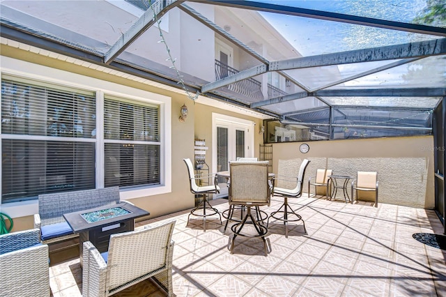 1411 Tessano Pl, Palm Harbor, FL 34683 - view of patio with a balcony, an outdoor fire pit, and glass enclosure