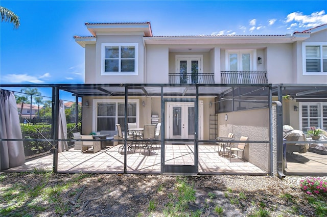 1411 Tessano Pl, Palm Harbor, FL 34683 - rear view of property featuring french doors, a balcony, stucco siding, a pergola, and a patio area