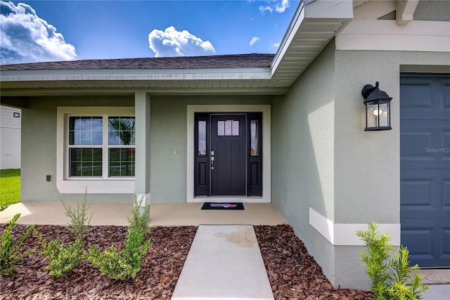 16433 66th Ln E, Parrish, FL 34219 - property entrance featuring stucco siding, roof with shingles, a porch, and a garage