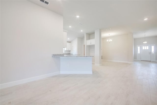 16433 66th Ln E, Parrish, FL 34219 - unfurnished living room with baseboards, light wood-style floors, a chandelier, lofted ceiling, and recessed lighting