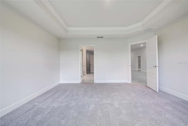 16433 66th Ln E, Parrish, FL 34219 - unfurnished bedroom with a tray ceiling, carpet flooring, crown molding, and baseboards