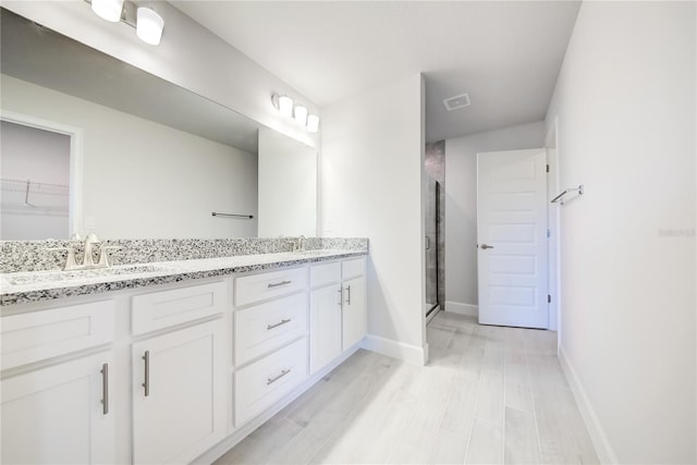 16433 66th Ln E, Parrish, FL 34219 - full bath featuring double vanity, a shower stall, baseboards, and a spacious closet