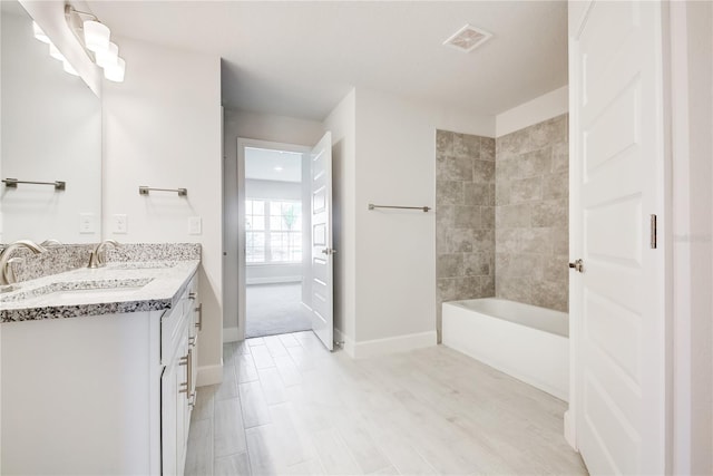 16433 66th Ln E, Parrish, FL 34219 - bathroom with double vanity, baseboards, and shower / bathtub combination