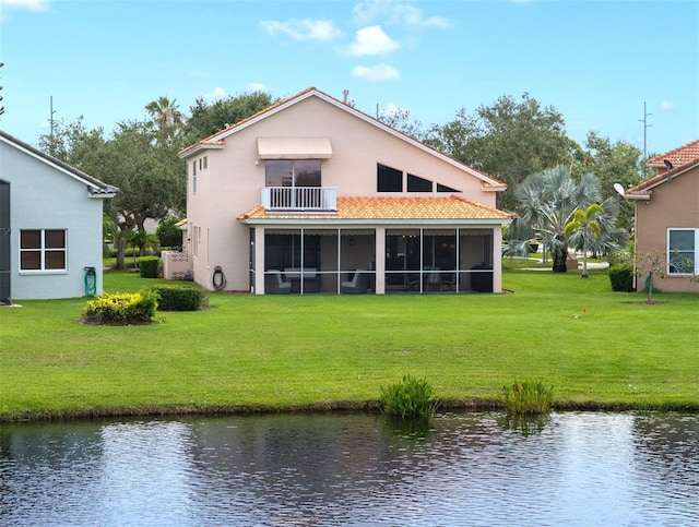 9800 Sago Point Dr, Seminole, FL 33777 - back of property featuring a water view, a balcony, a tiled roof, and stucco siding
