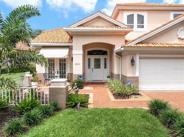 9800 Sago Point Dr, Seminole, FL 33777 - view of front of property featuring stucco siding, an attached garage, and a tile roof