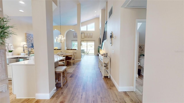 9800 Sago Point Dr, Seminole, FL 33777 - entrance foyer with a chandelier, light wood-style floors, baseboards, a towering ceiling, and recessed lighting