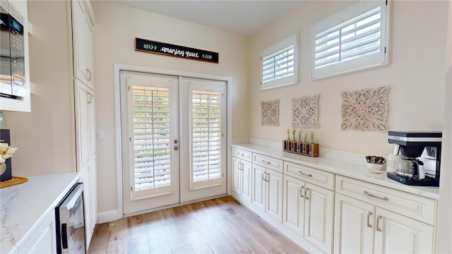 9800 Sago Point Dr, Seminole, FL 33777 - doorway with french doors, light wood-style flooring, and plenty of natural light