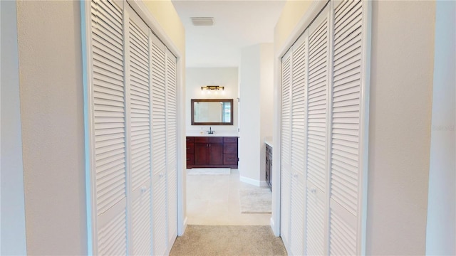 9800 Sago Point Dr, Seminole, FL 33777 - hall featuring a sink and light carpet