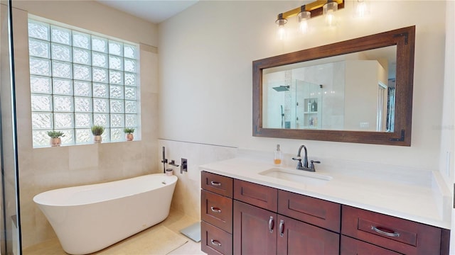 9800 Sago Point Dr, Seminole, FL 33777 - bathroom featuring vanity, a freestanding tub, a shower stall, and tile walls