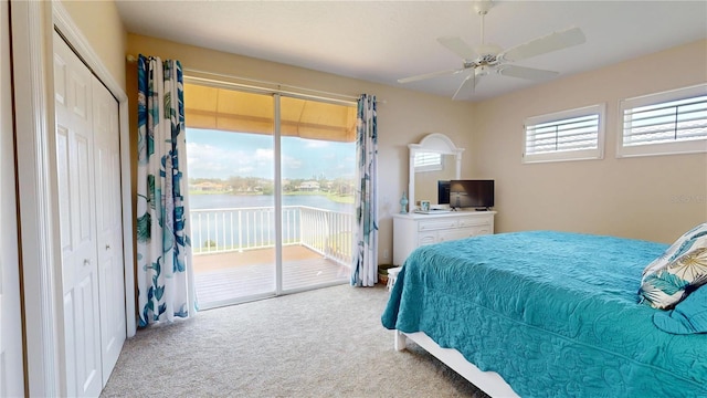 9800 Sago Point Dr, Seminole, FL 33777 - carpeted bedroom featuring access to outside and ceiling fan