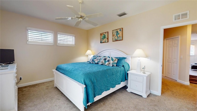 9800 Sago Point Dr, Seminole, FL 33777 - bedroom featuring light carpet, multiple windows, and baseboards