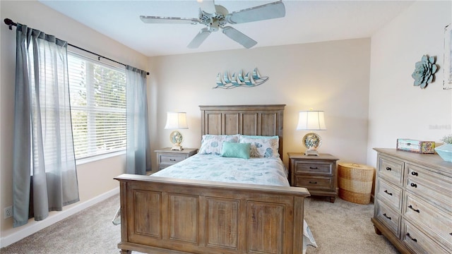 9800 Sago Point Dr, Seminole, FL 33777 - bedroom with light carpet, a ceiling fan, and baseboards