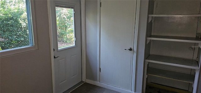 11511 113th St Unit 4F, Seminole, FL 33778 - doorway with dark tile patterned floors and plenty of natural light