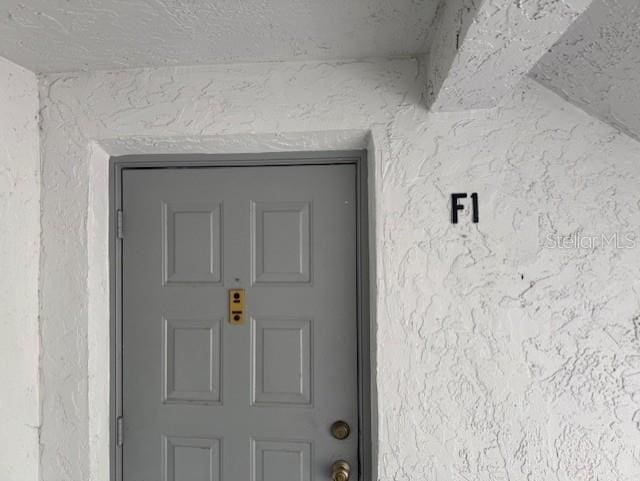 1258 Pine Ridge Cir W Unit F1, Tarpon Springs, FL 34688 - entrance to property with stucco siding